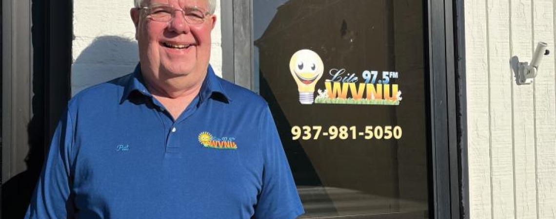 Pat Hays posing in front of his radio station building in Greenfield, Ohio.