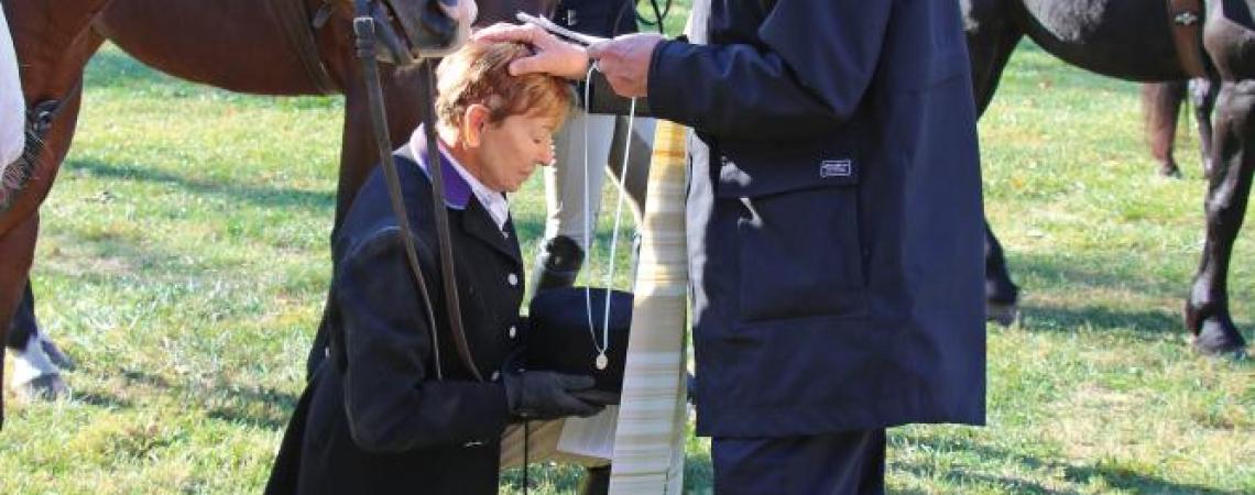 A rider being blessed before a fox hunt.