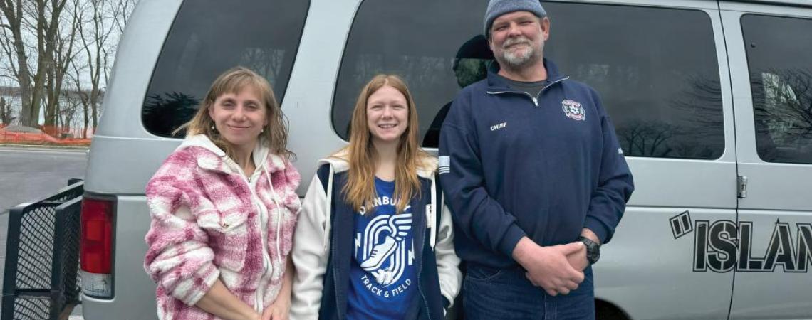 The Skeans family posing with their rideshare van