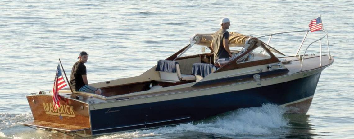 Two men riding a boat in Lake Erie