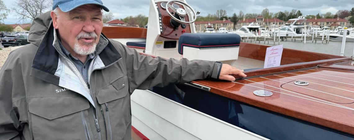 A man posing with a Lyman boat