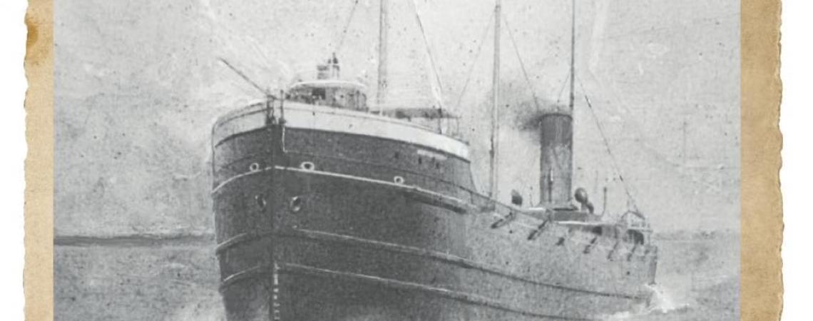 A black and white photo of a ship at sail