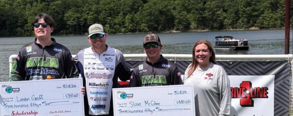 Two young fishermen at a fishing competition with their captain and director