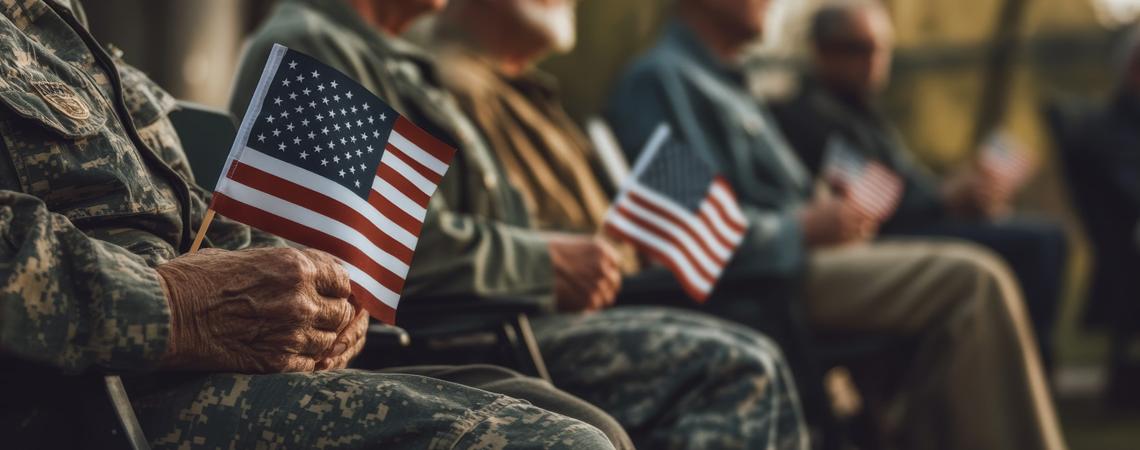 Veterans sitting with American flags