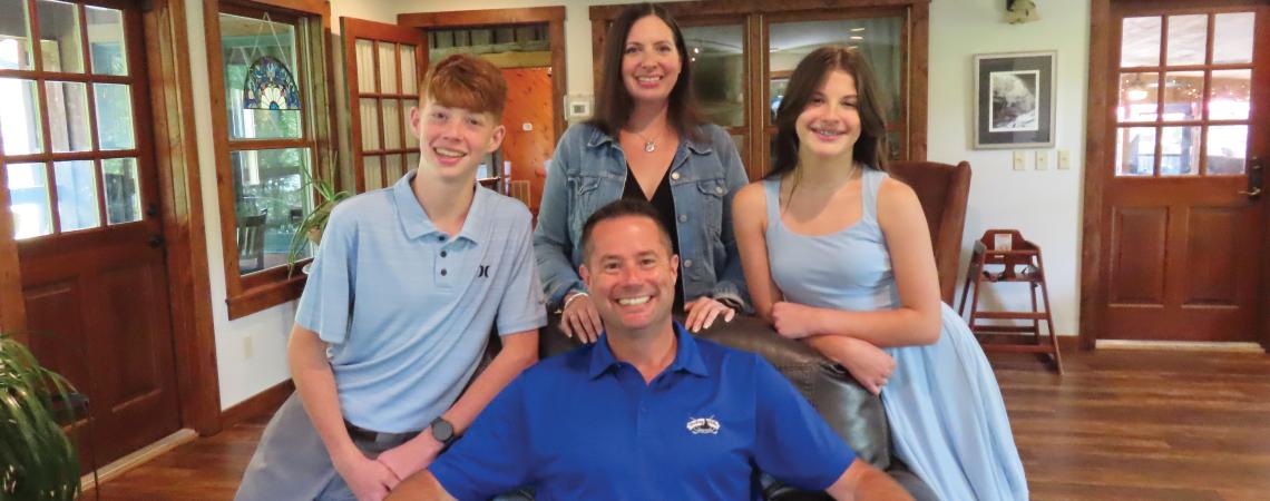A family of four posing for a photo