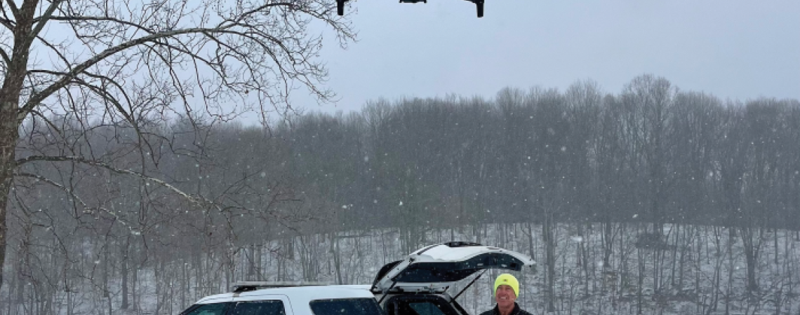 A police officer flying a drone