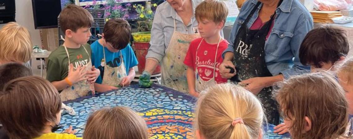 Two women teaching children in an art class
