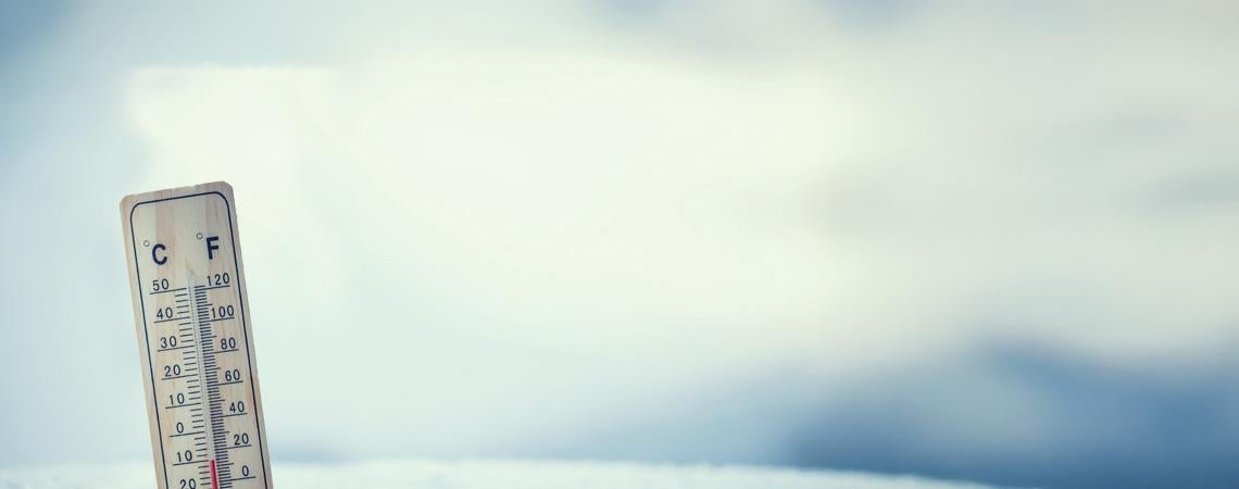 A thermometer stuck in a snowy field