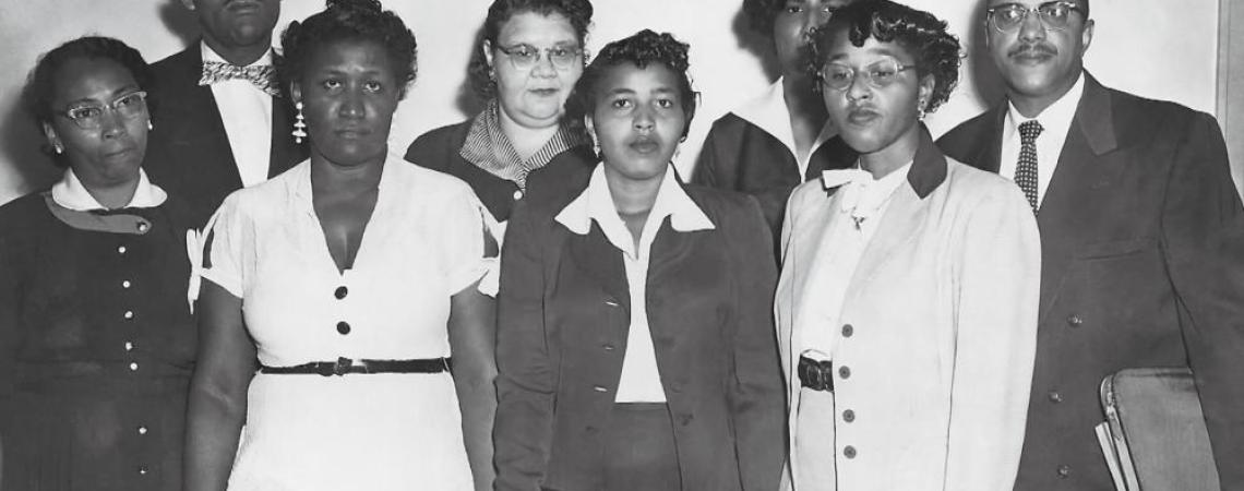 A black and white photo of a group of people fighting for integration