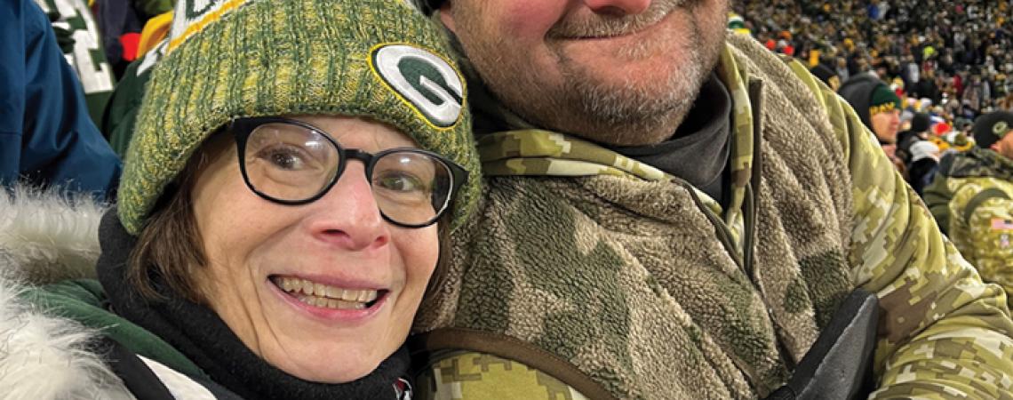 man and woman in stands at game