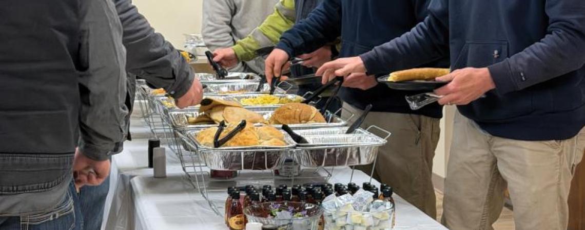 Lineworkers taking a break from restoring power to have a meal