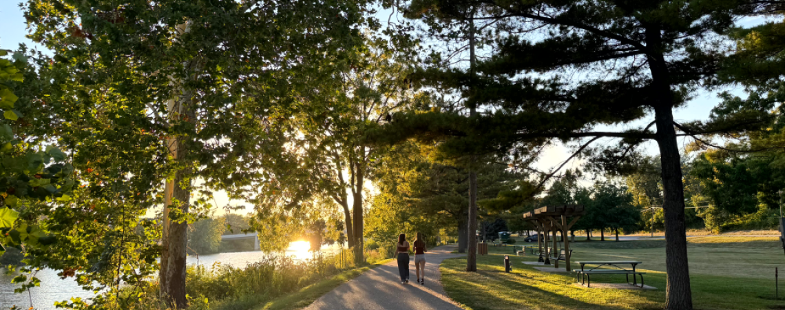 People walking on a trail at sunset