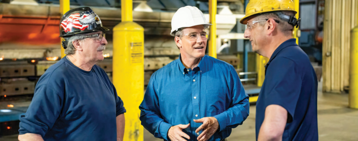 Jon Husted talking with people in hard hats