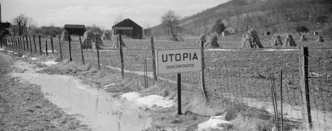 A black and white photo of a rural Ohio landscape with a Utopia city sign