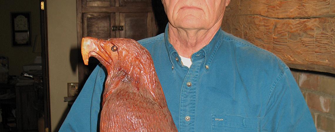 Tim Kuenning holding carving