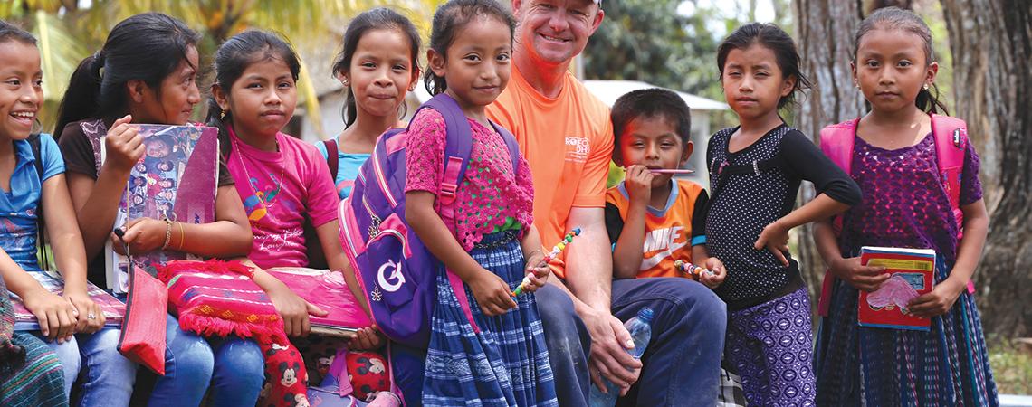 Lineworker with Guatemalan children