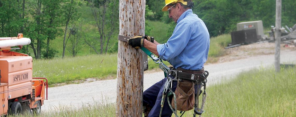 Lineworker ascending pole