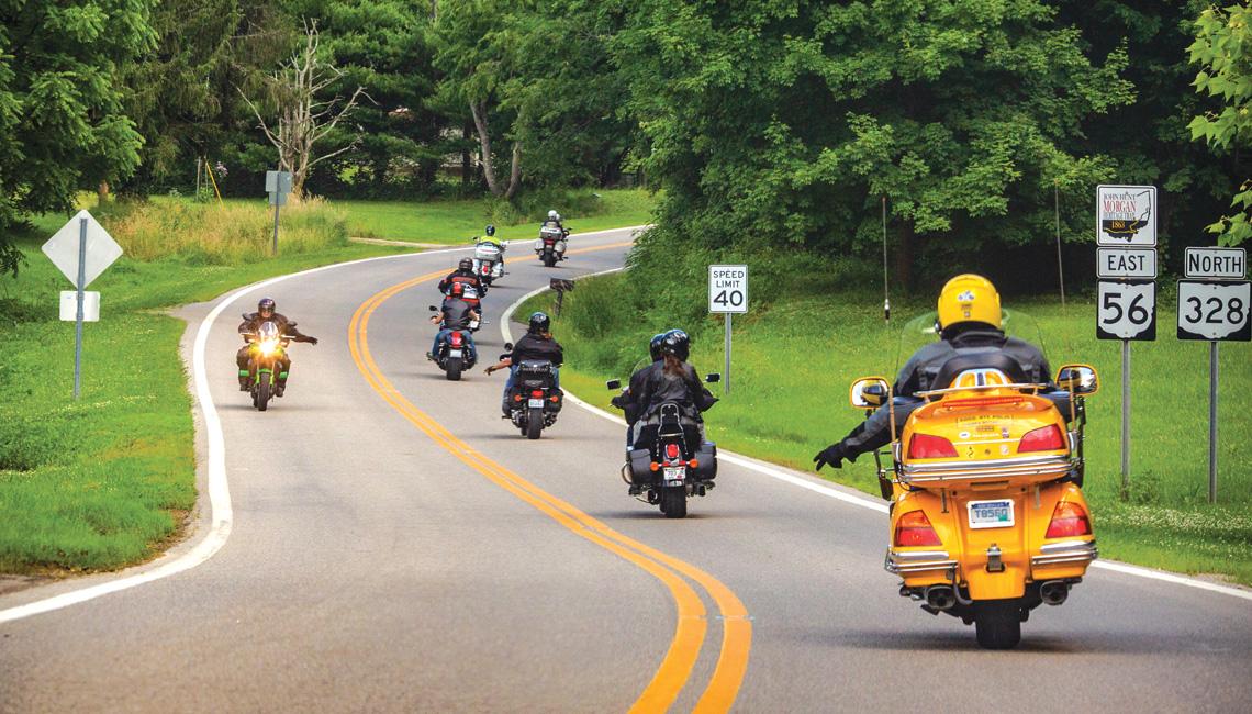 Motorcycle riders signaling to each other on the road.