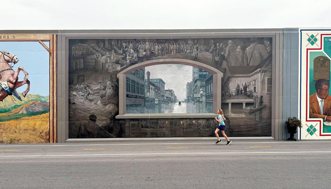 Runner in front of Portsmouth floodwall murals